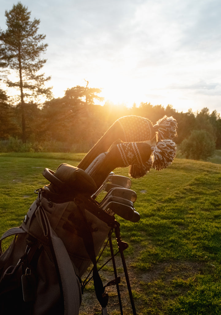 Knit wool golf headcovers with Nordic patterns on golf bag at sunset – premium golf accessories with character and tradition